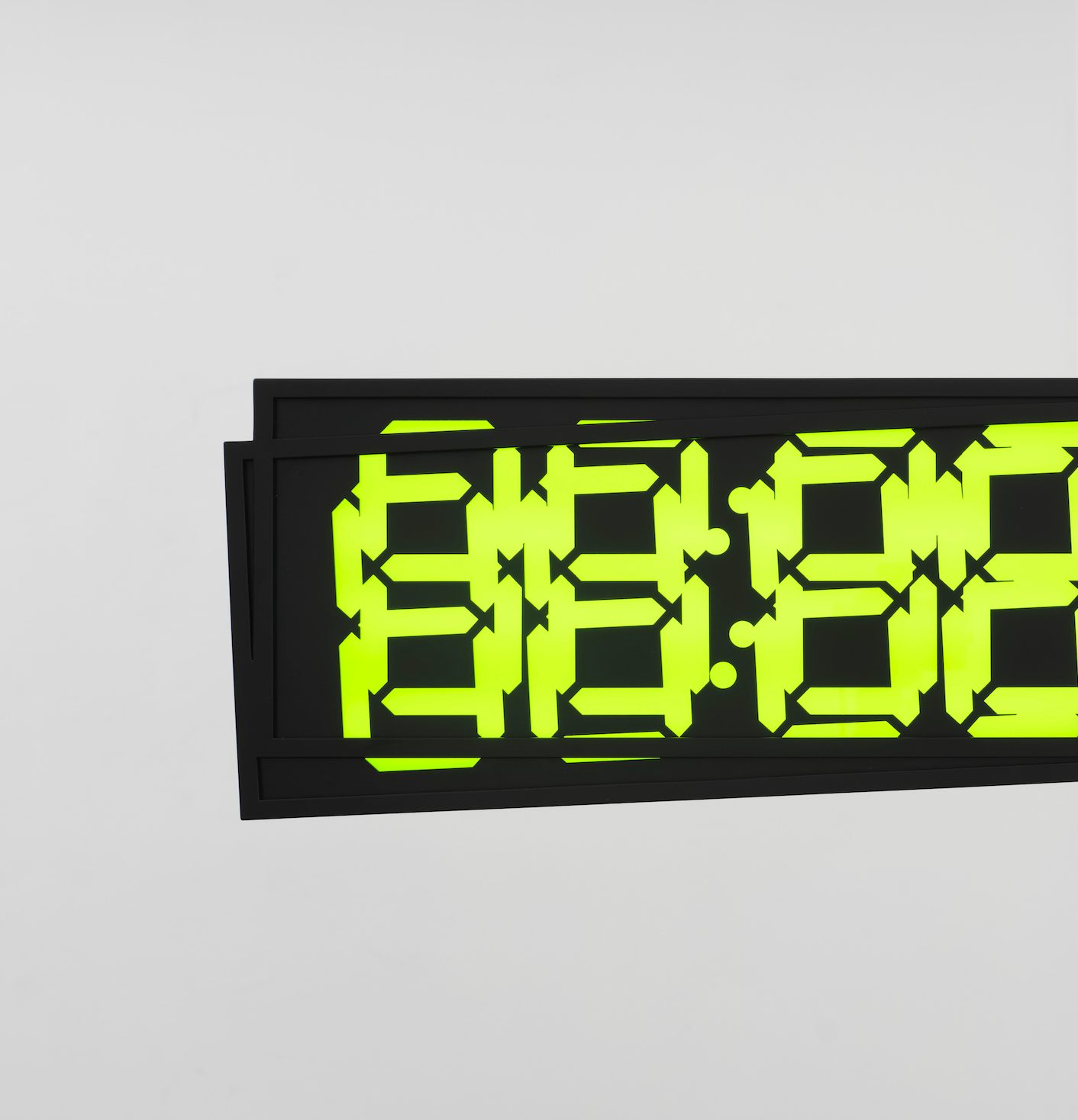 A digital clock showing "88:88" in bright green on a black screen, mounted on a white wall.