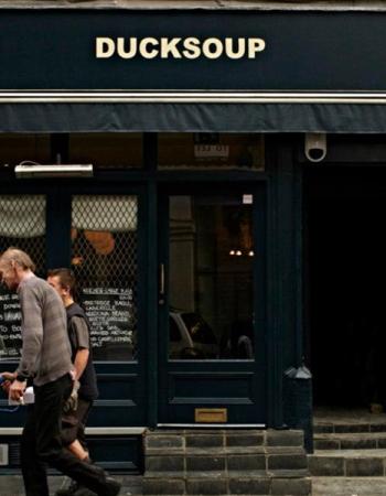 Exterior view of "DUCKSOUP" restaurant at number 41, with two people walking past.