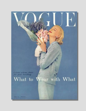 A vintage image of a blonde woman in a blue suit smelling a bouquet of pink and purple flowers, with "VOGUE" at the top and "What to Wear with What" below.