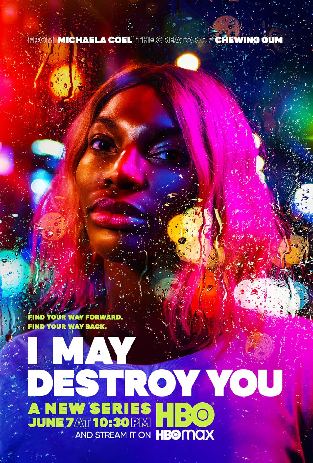 An 'I May Destroy You' poster showing Michaela Coel with pink hair, illuminated by vibrant neon lights, seen through a rain-splattered window.