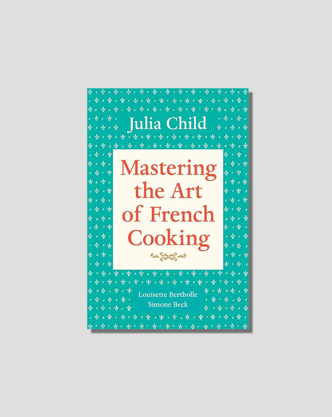 Cover of Julia Child's 'Mastering the Art of French Cooking', teal with white fleur-de-lis pattern and red title text.