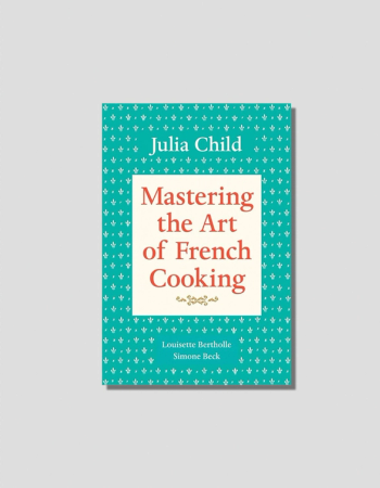 Cover of Julia Child's 'Mastering the Art of French Cooking', teal with white fleur-de-lis pattern and red title text.