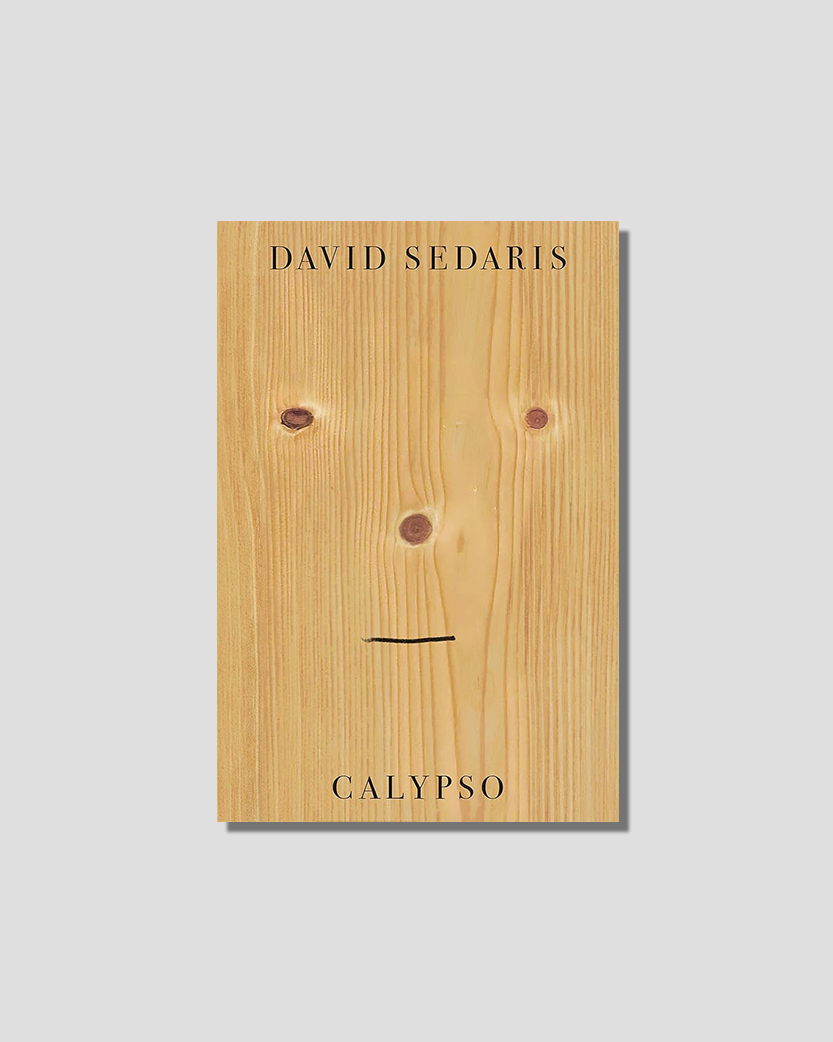 Book cover for David Sedaris's Calypso, featuring a light wood plank with knots arranged as eyes and nose, and a drawn line for a mouth.