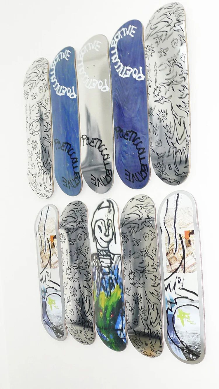 Ten skateboard decks, featuring various designs including "POETICAL COLLECTIVE" text, abstract patterns, and a smiling character, displayed in two rows.