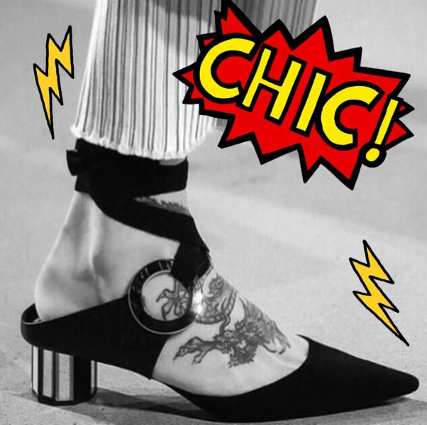 A tattooed foot in a black pointed-toe mule with ankle straps, overlaid with a red "CHIC!" speech bubble and yellow lightning bolts.