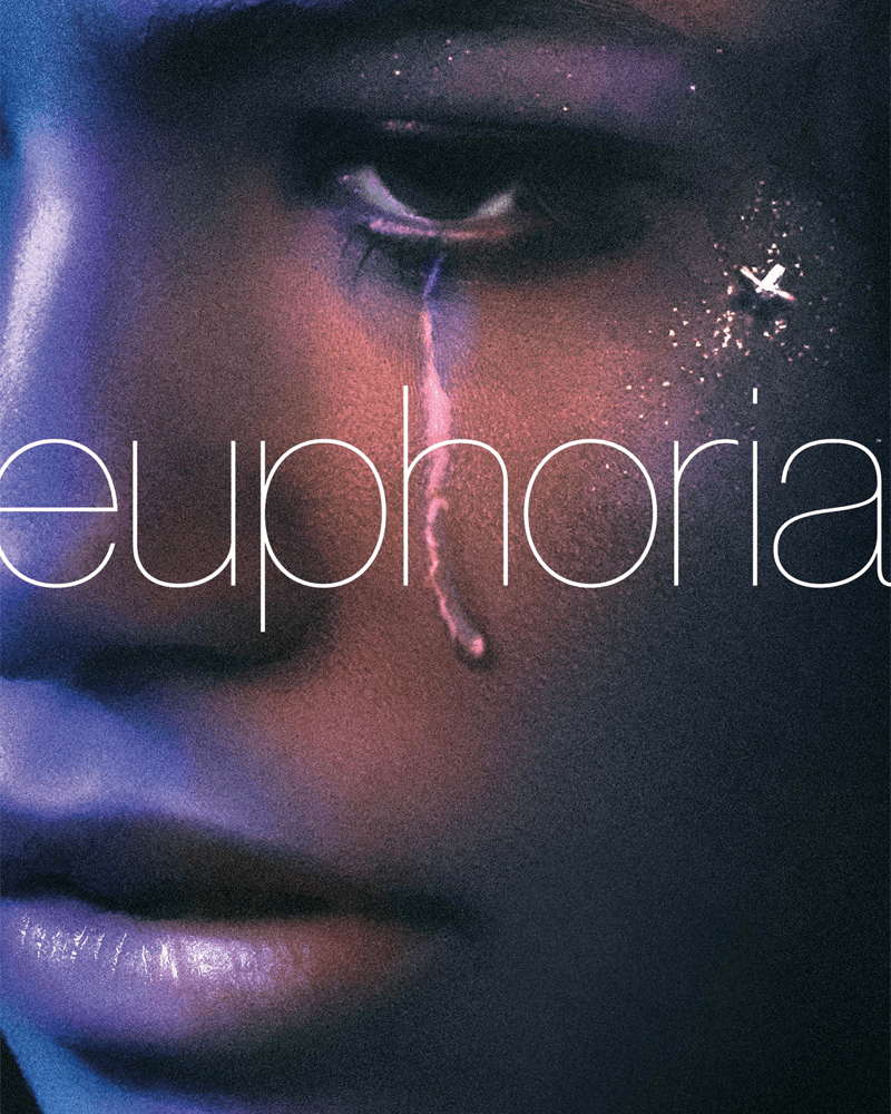 A close-up of a person's face with a glistening tear running from their eye, glitter makeup, under purple and pink light, with the word "euphoria."