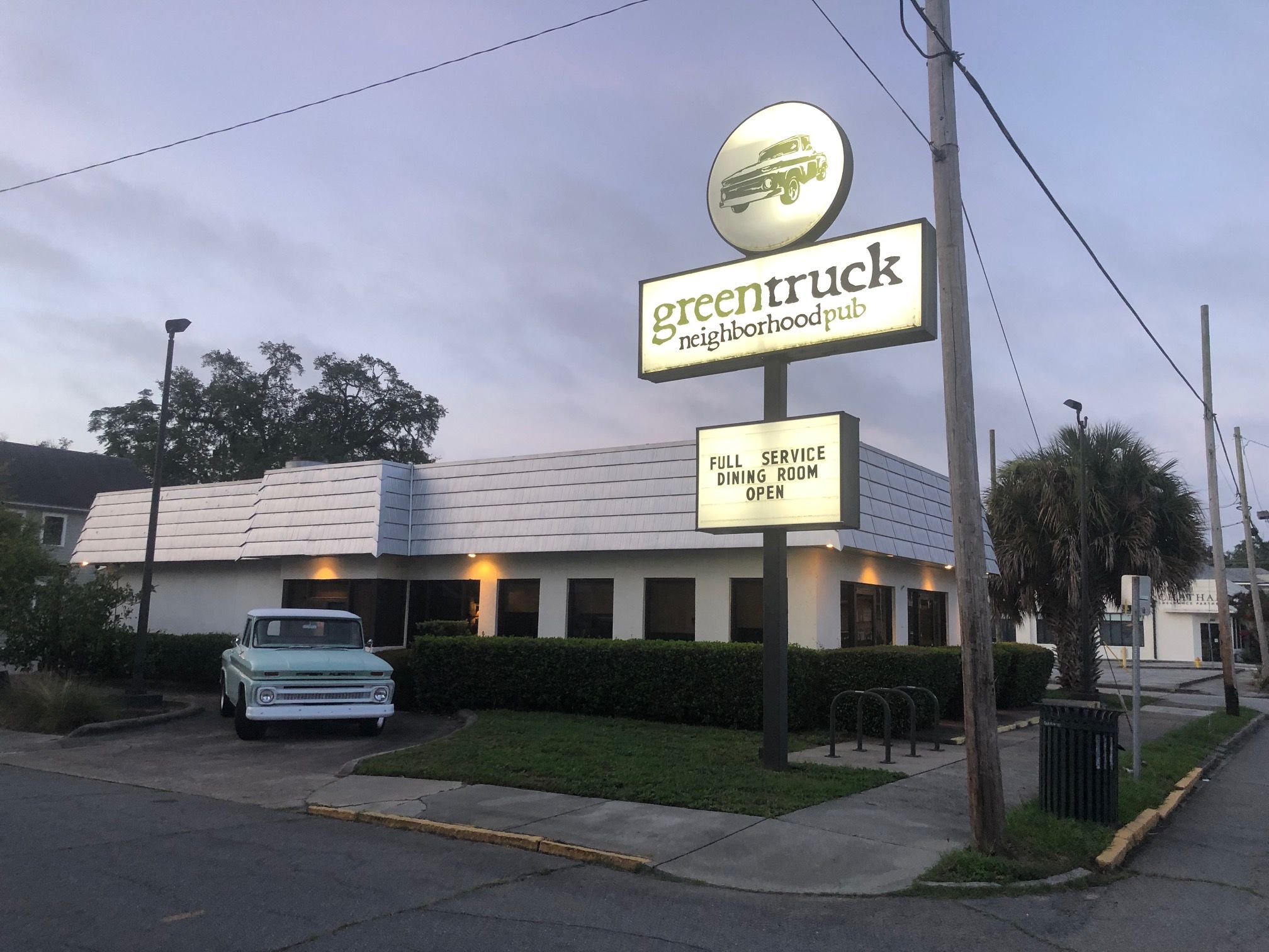 Greentruck neighborhood pub with a vintage light blue pickup truck parked outside.