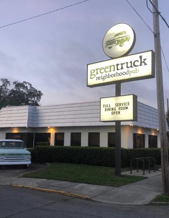Greentruck neighborhood pub with a vintage light blue pickup truck parked outside.