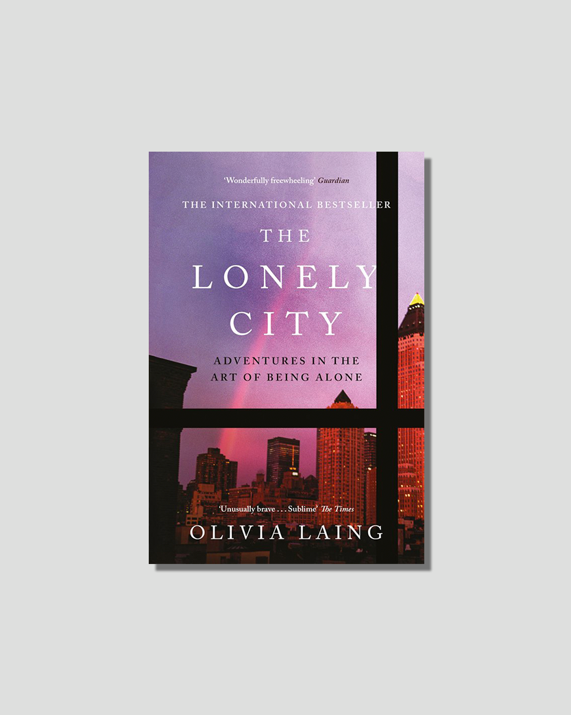 Book cover for "The Lonely City" by Olivia Laing, featuring a purple and pink cityscape viewed through a window.
