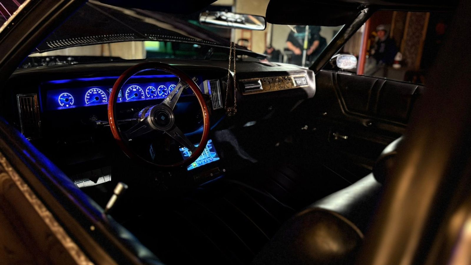 Custom interior — wood-grain wheel and digital dash