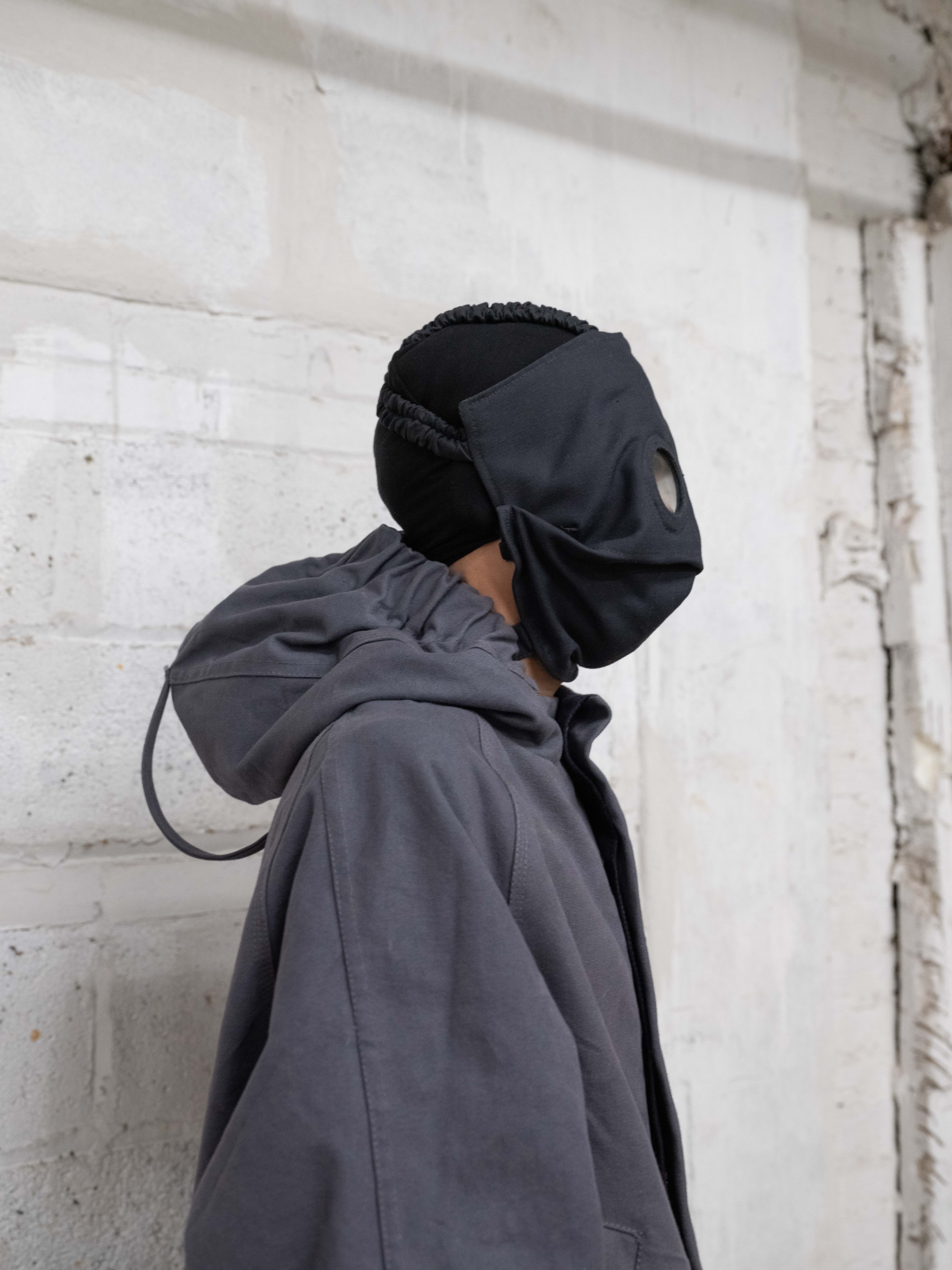 profile view of man wearing Rocket Conductor Mask and Lunar Coat from bryan jimenez fall/winter 2022