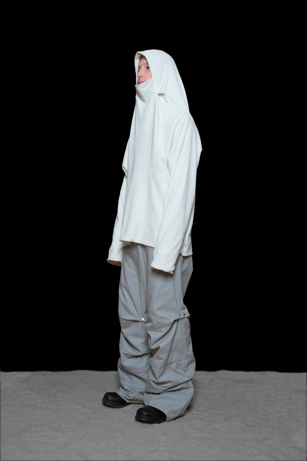 man wearing polaris hooded thermal and darted trousers from bryan jimenez fall winter 2020