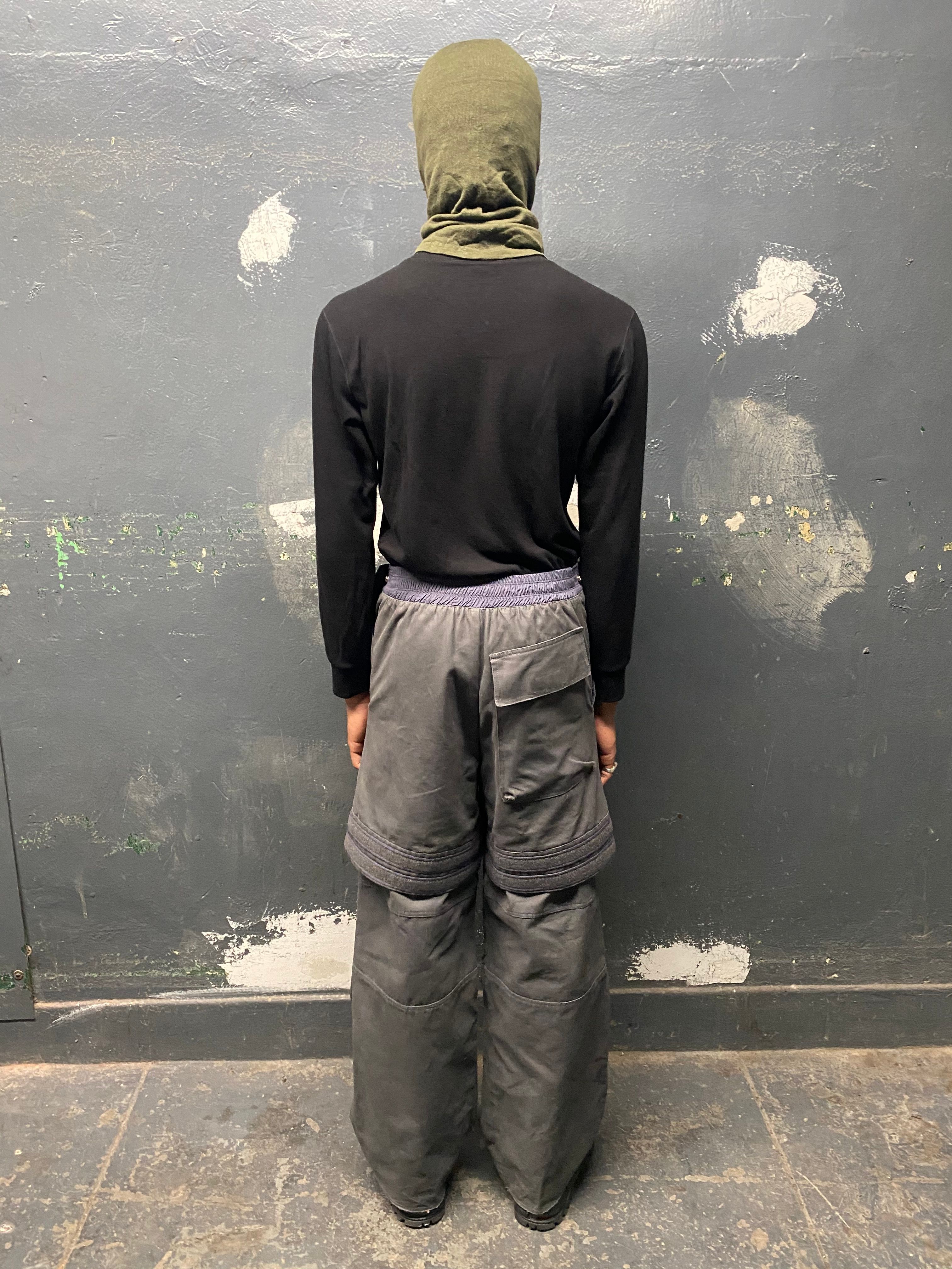 back view man wearing amu trousers v2, pilot balaclava and silk weight top from bryan jimenez fall/winter 2022 