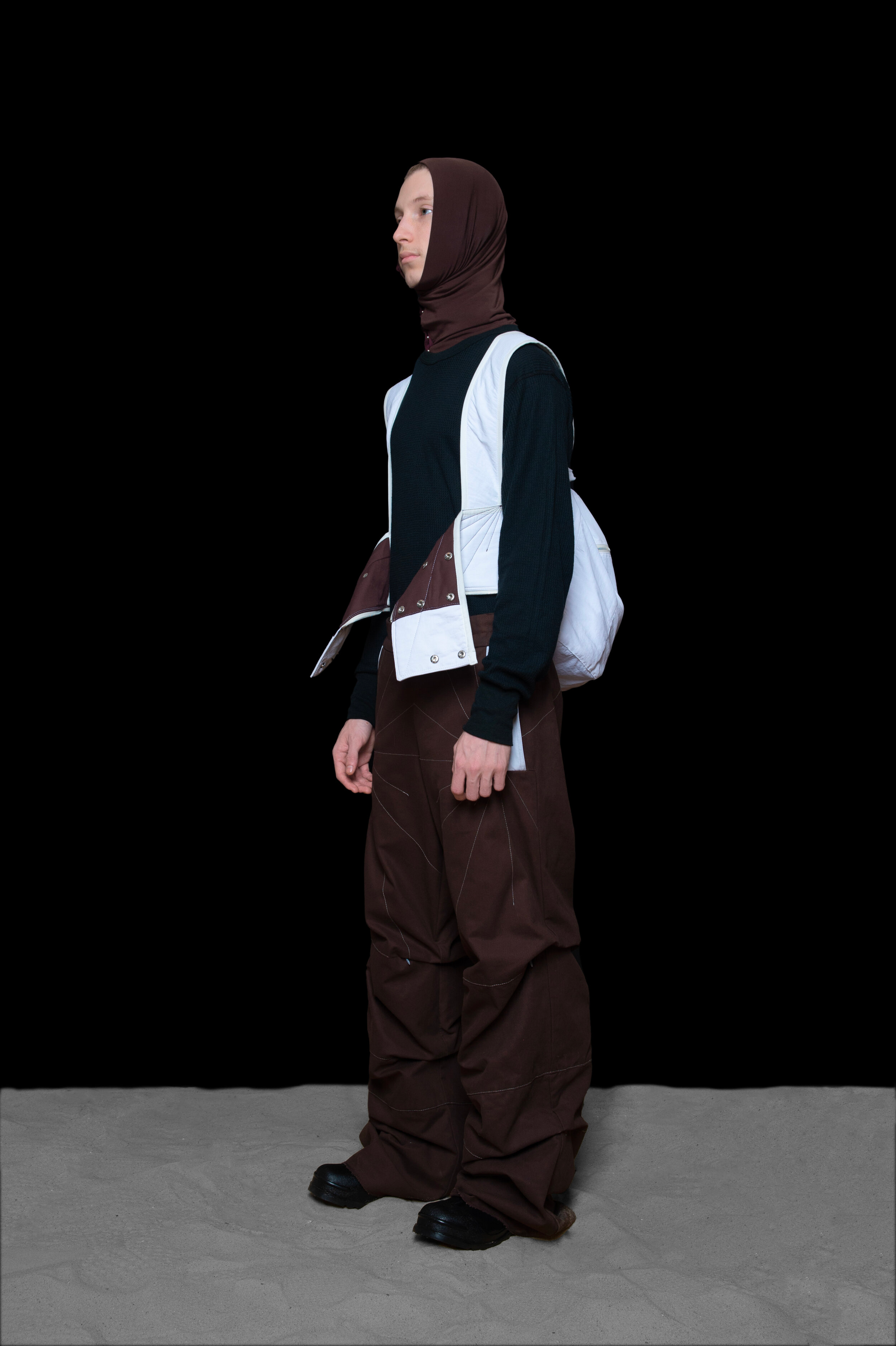 man wearing tactical head scarf, oxygen bag, and darted trousers from bryan jimenez fall winter 2020