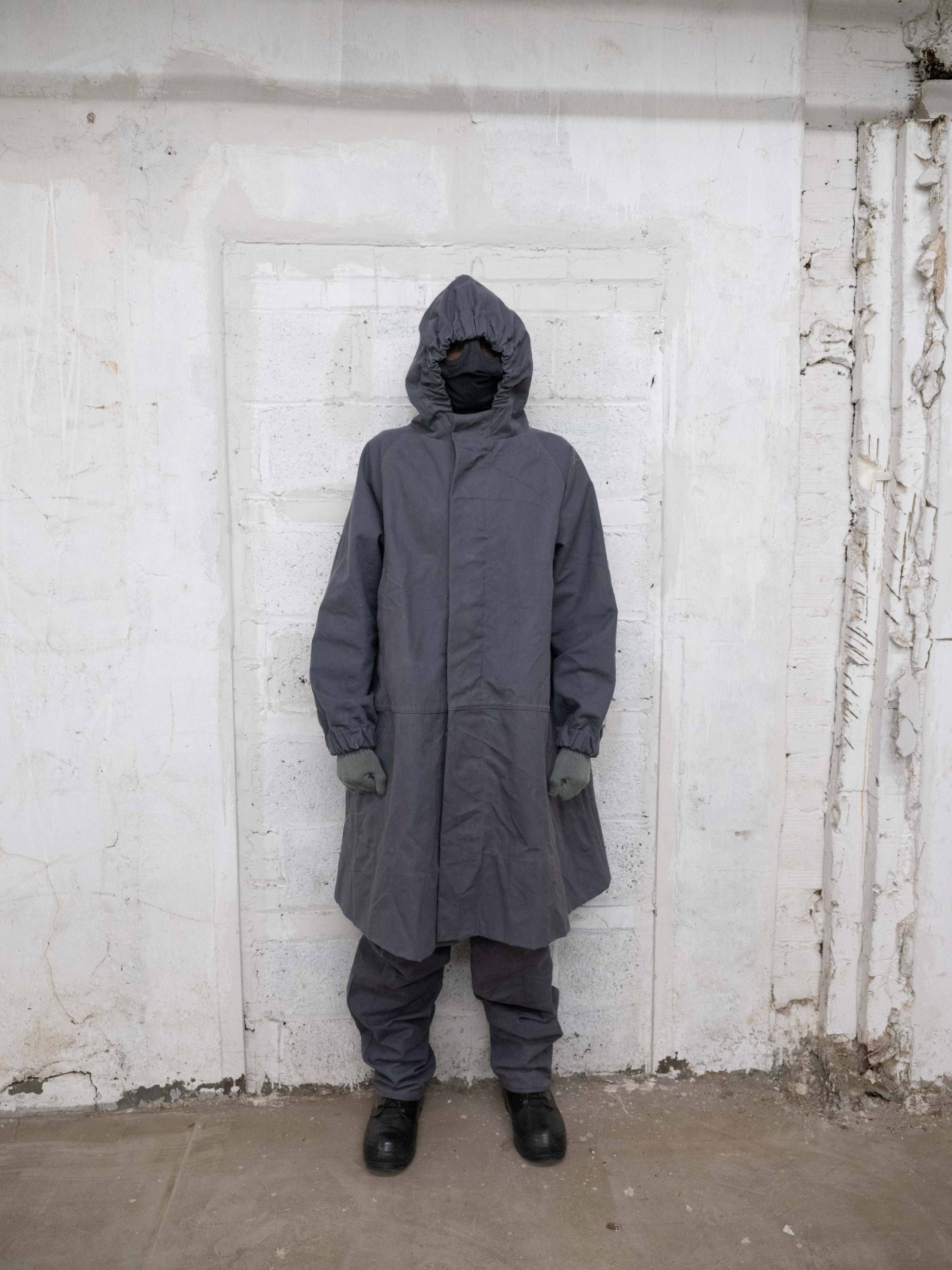 Man wearing Lunar coat, lunar trousers, bunny boots and rocket conductor mask From bryan jimenez fall/winter 2022