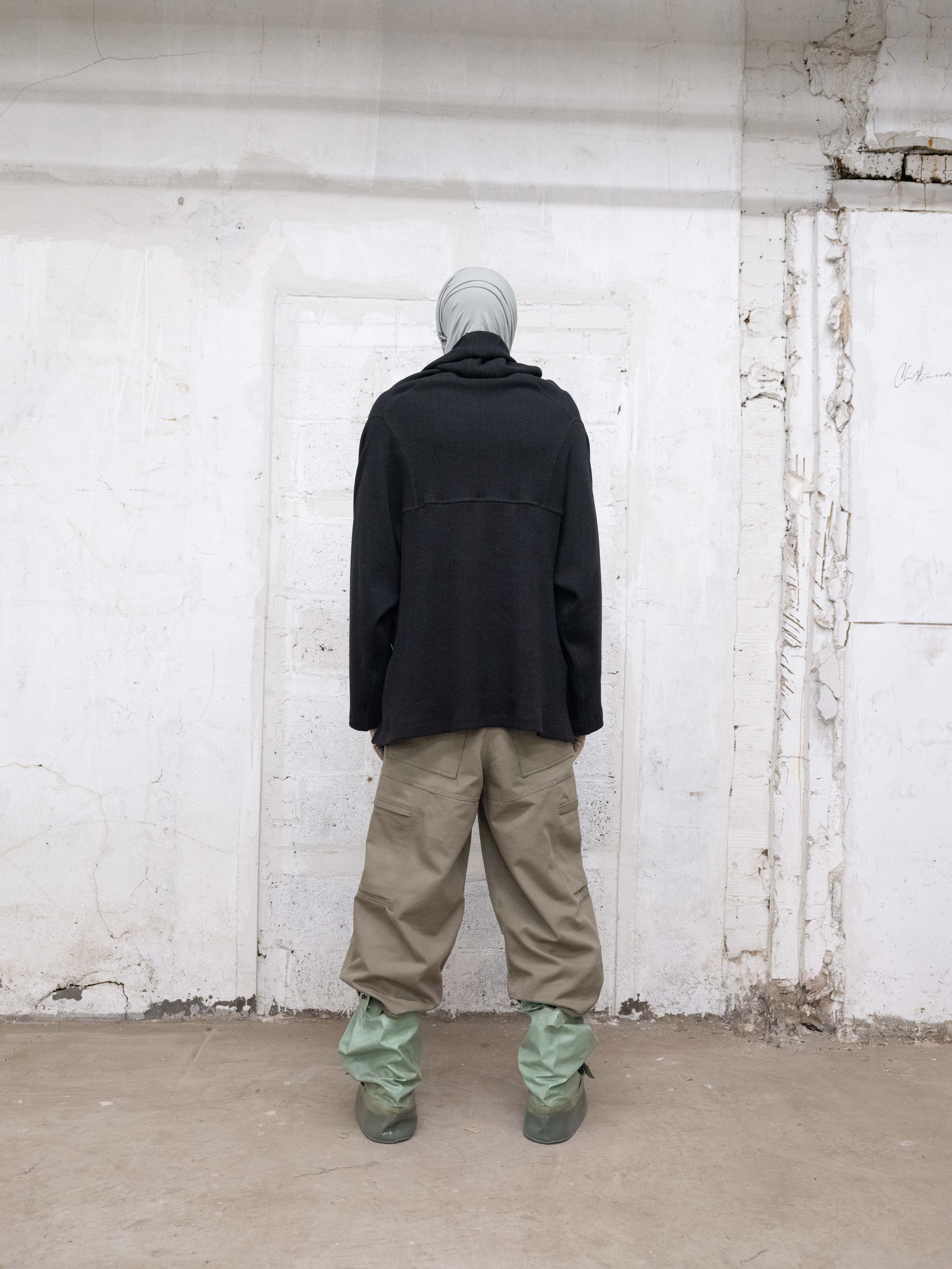 man wearing headscarf v2, single layered armstrong hoodie, cover boots and 3/4 station trousers from bryan jimenez fall/winter 2022