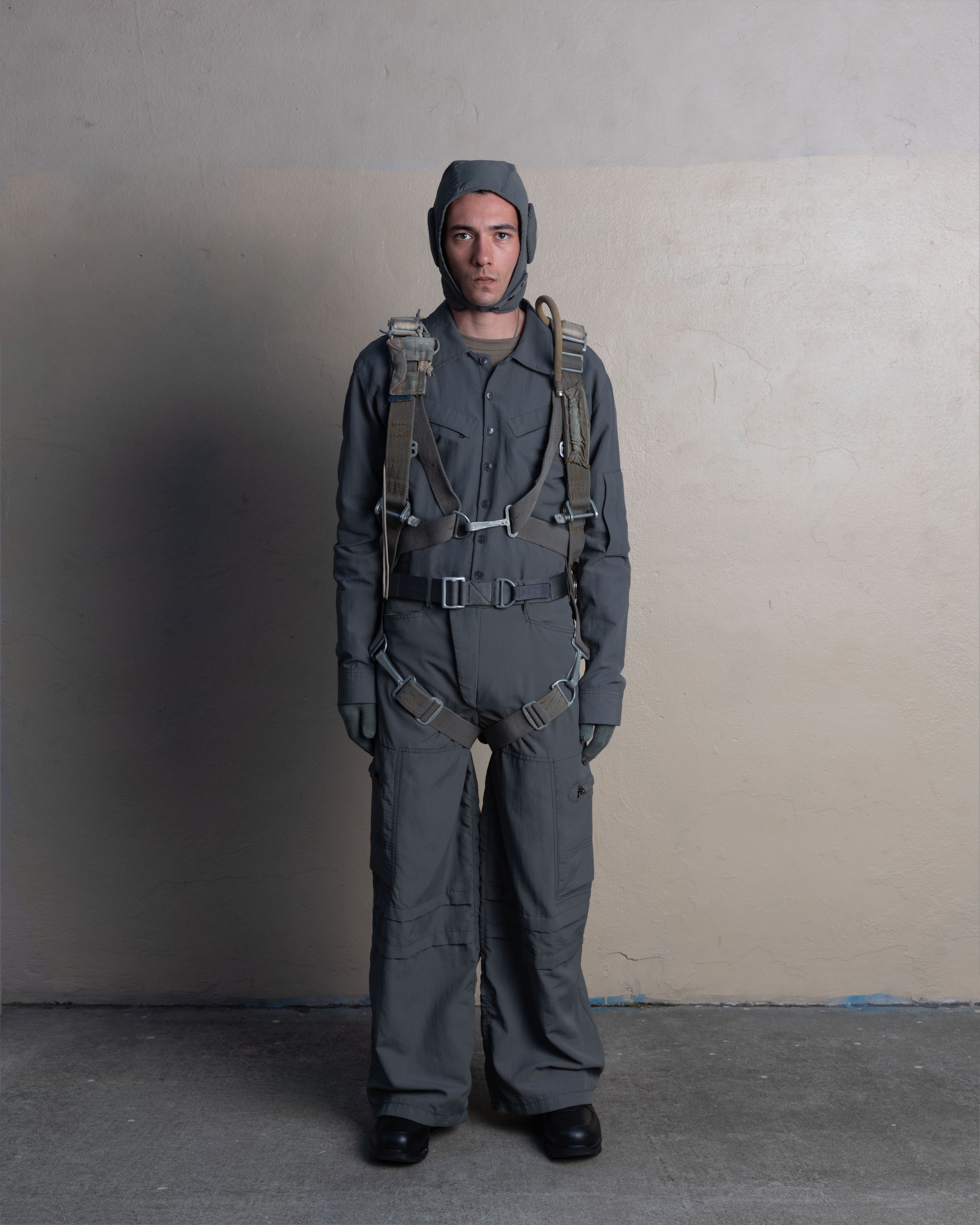 man wearing flyer helmet, pilot shirt, and station trousers from bryan jimenez spring summer 2023