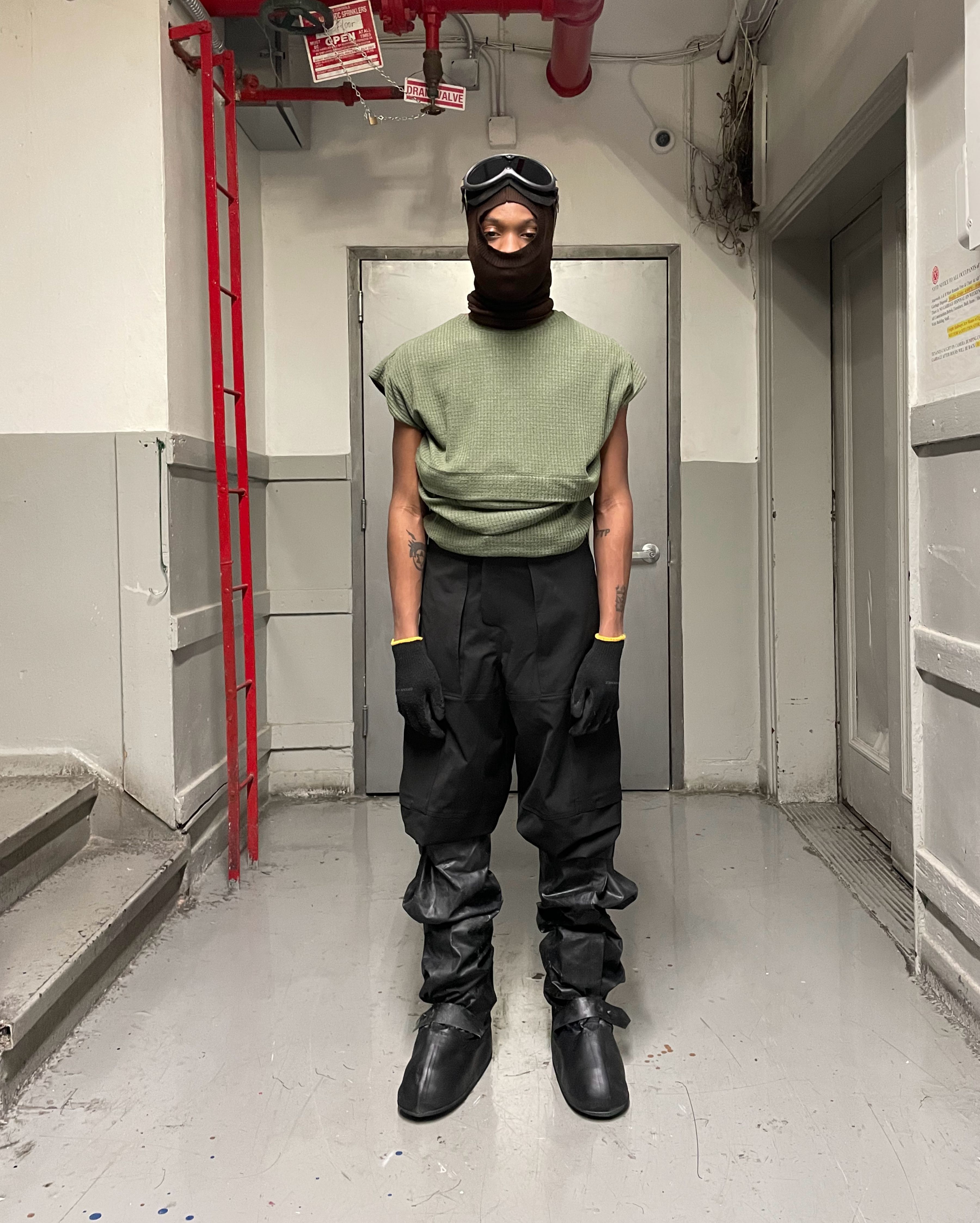 man wearing headscarf v2, uniform trousers, and cover boots from bryan jimenez spring summer 2022