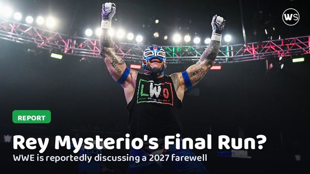 Rey Mysterio celebrating in the ring with his arms raised