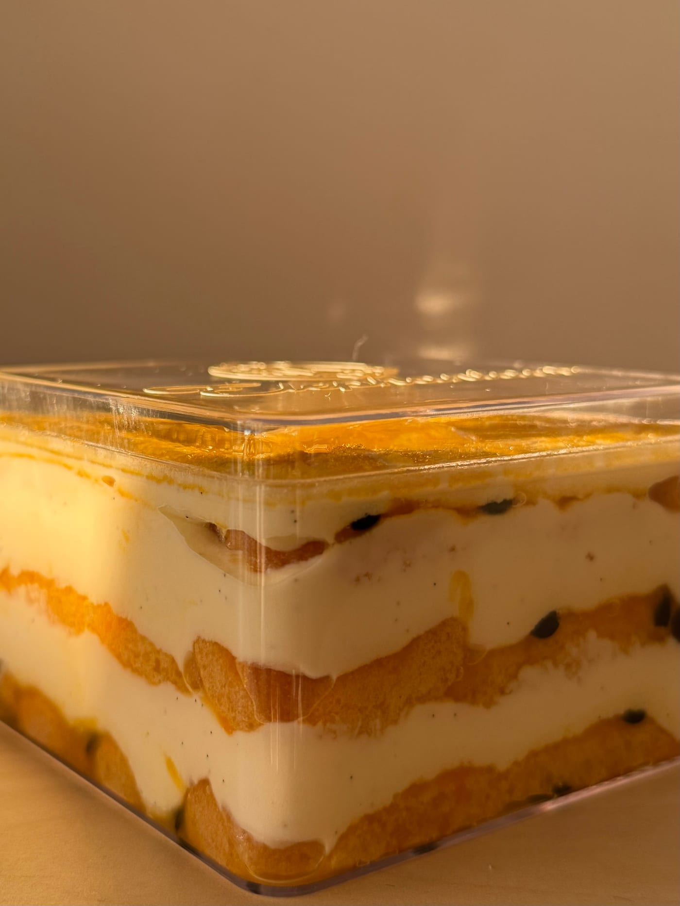 Passion fruit honeycomb tiramisu cross-section showing layered mascarpone cream and ladyfingers