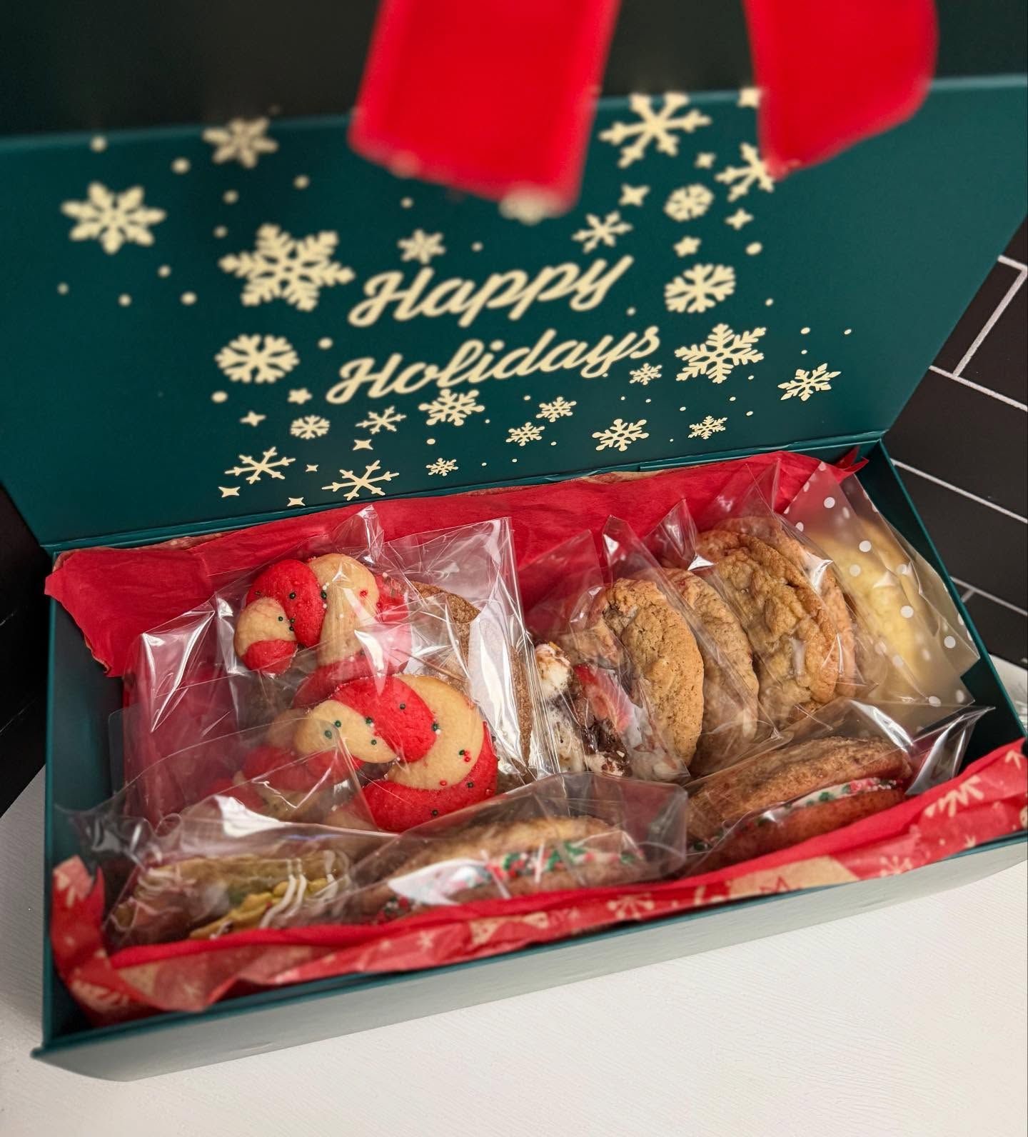 Open holiday cookie box with festive sugar cookies
