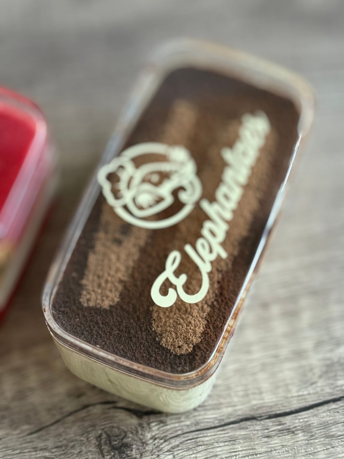 Classic Italian tiramisu with cocoa-dusted Elephantaes branded top