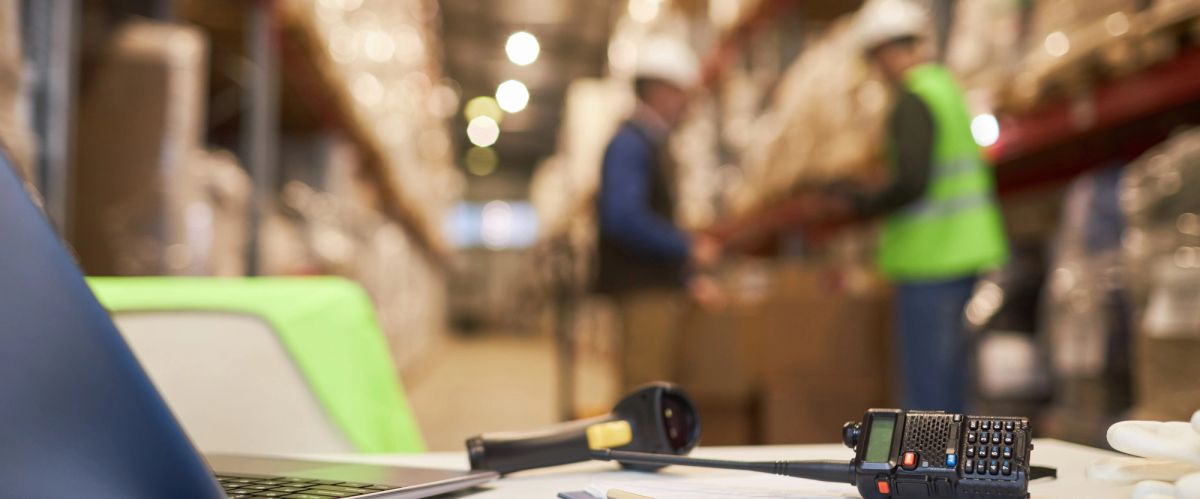Warehouse desk with a handheld scanner and packages