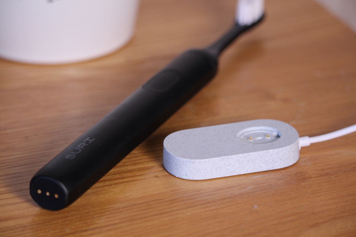 SURI electric toothbrush with pebble charging dock