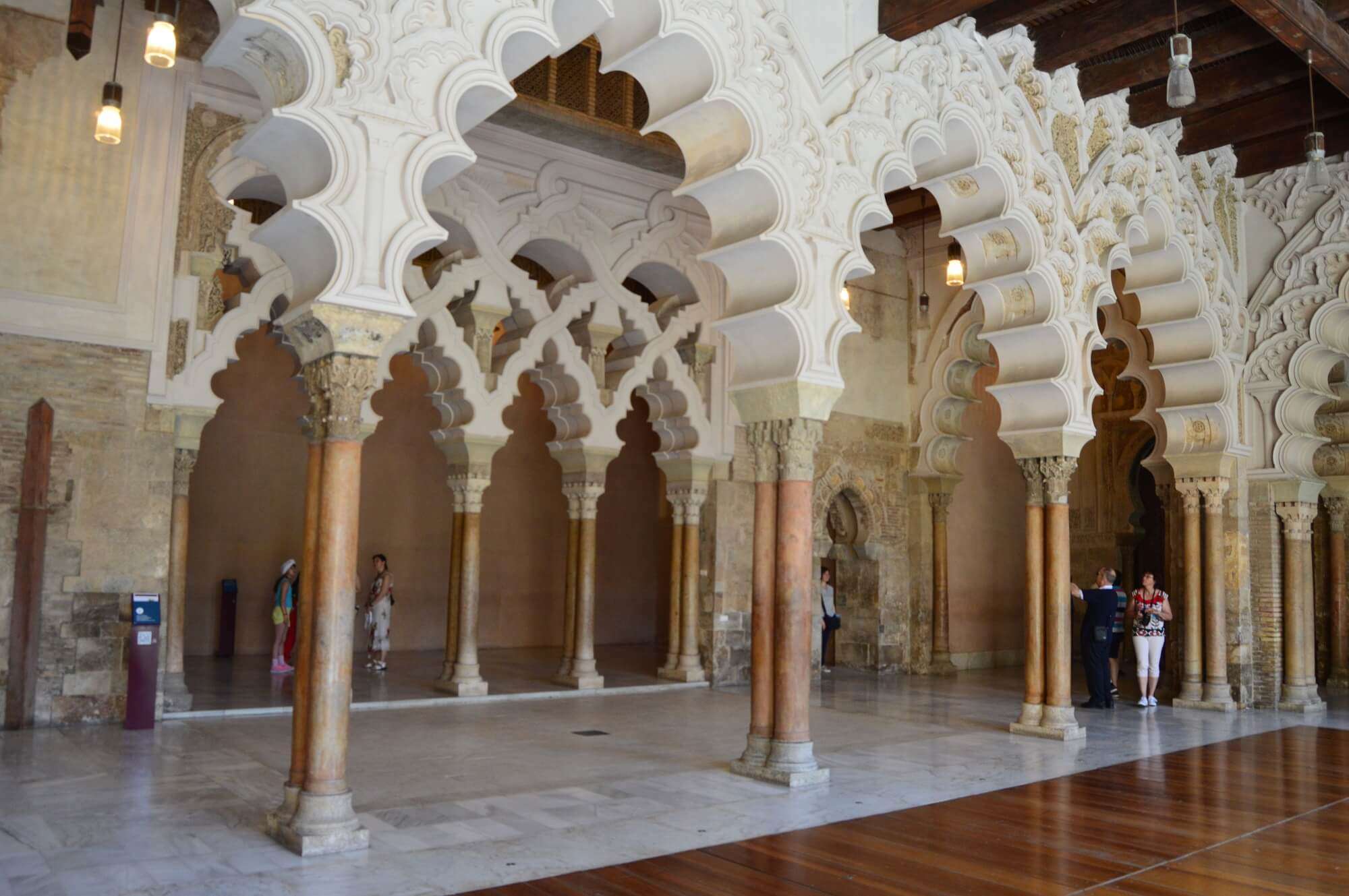Moorish arches and ornate columns inside the Aljafería Palace in Zaragoza, Aragon, Spain