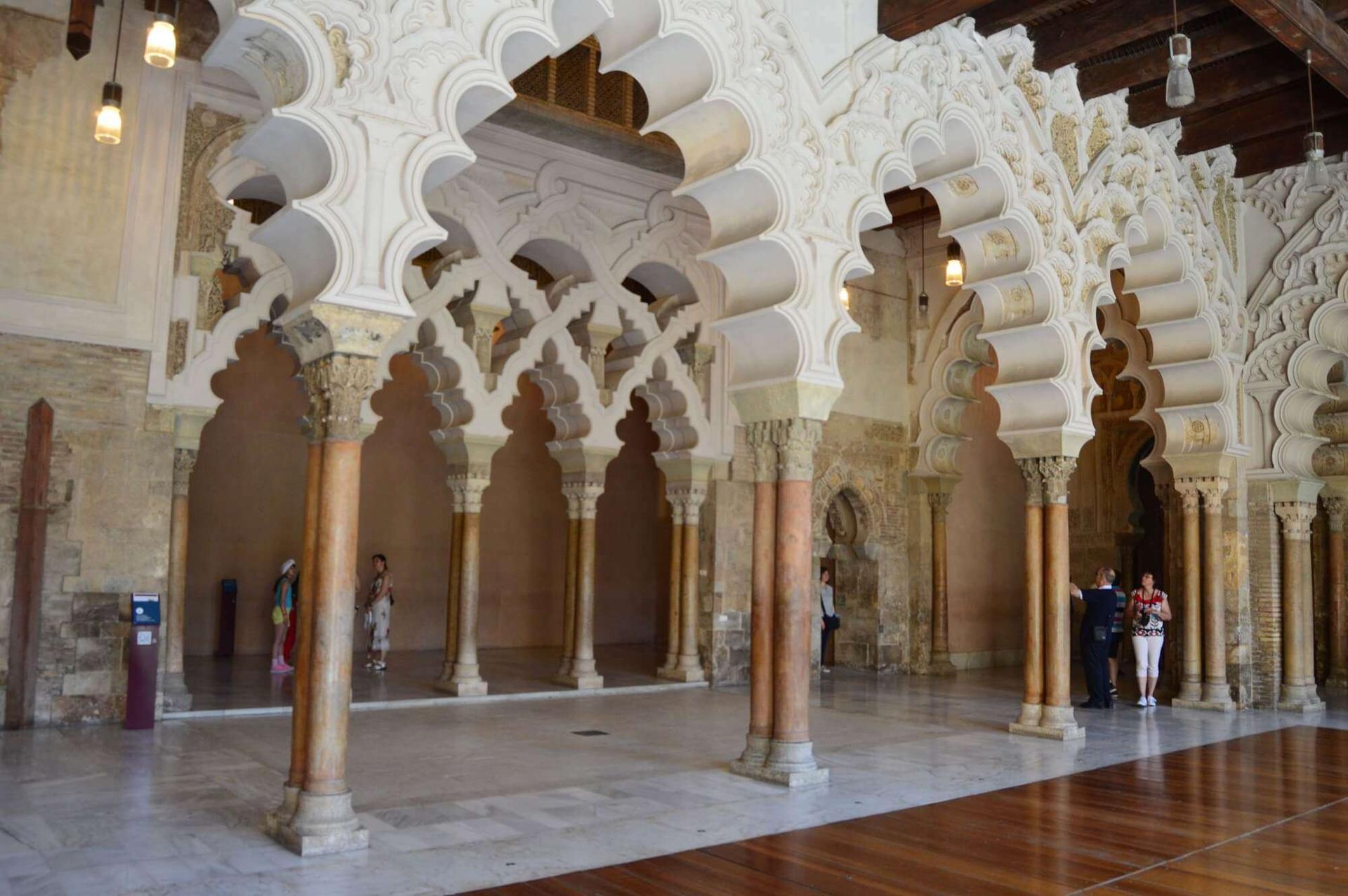 Moorish arches and ornate columns inside the Aljafería Palace in Zaragoza, Aragon, Spain