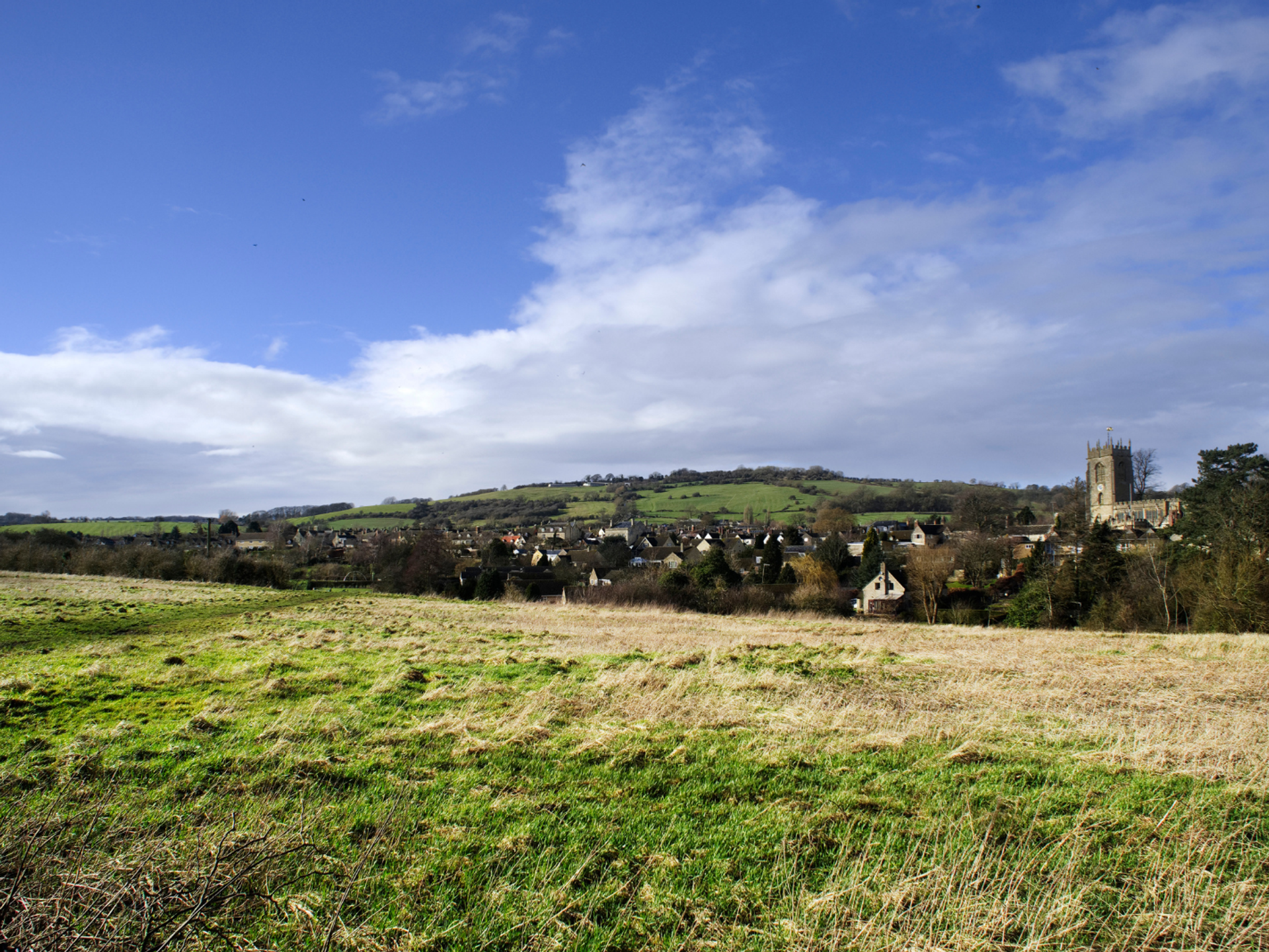 View across Winchcombe and the surrounding Cotswold hills.