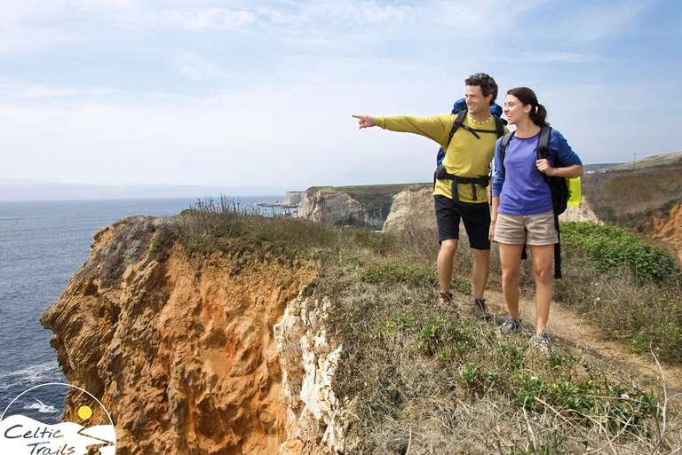 Couple enjoying a walking holiday on a sunny coastal path