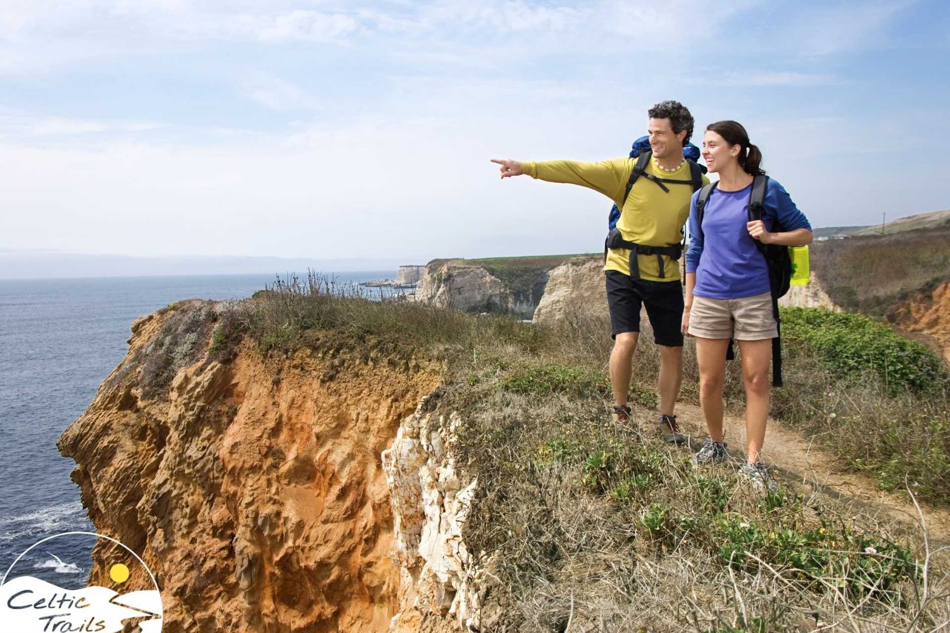 Couple enjoying a walking holiday on a sunny coastal path