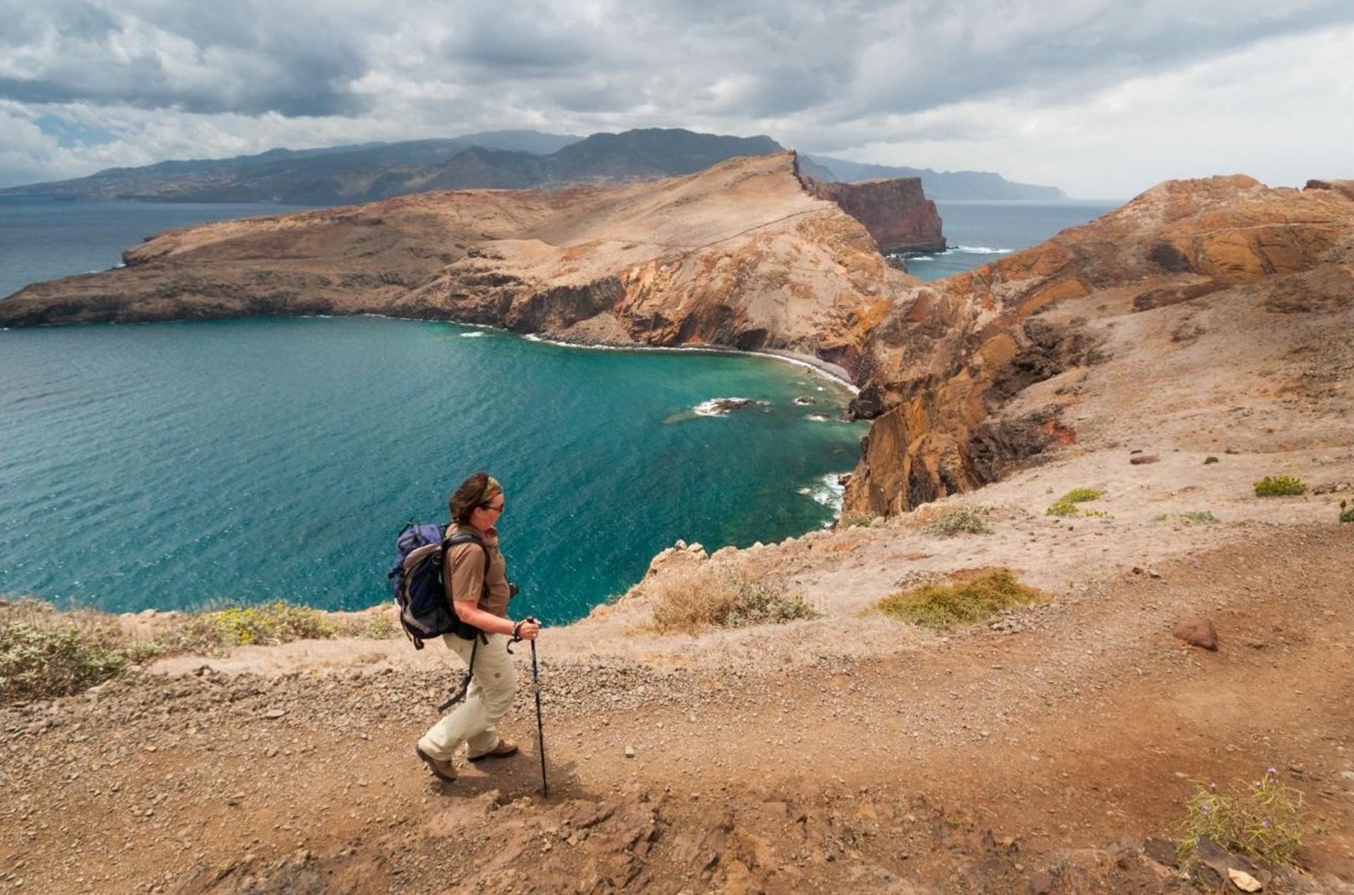 Walker on the Ponta de São Lourenço coastal trail overlooking the Atlantic.