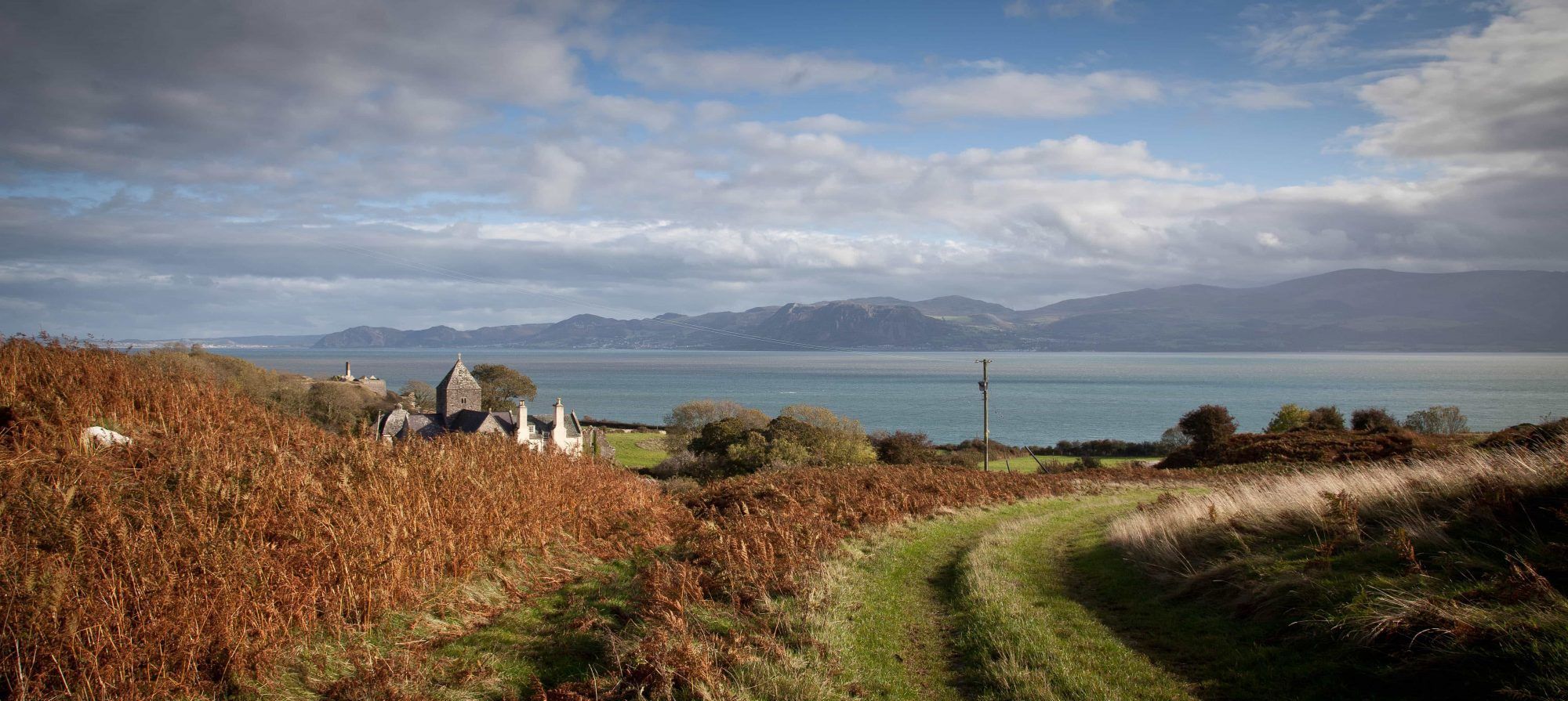A scenic view of a mountain landscape with a clear blue sky.