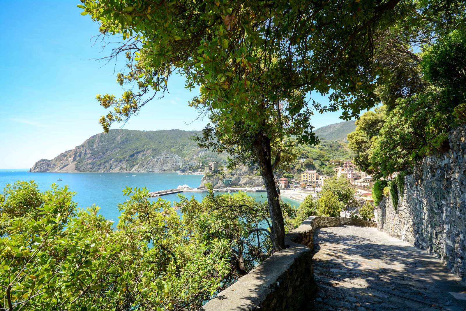 Hiker on a coastal path along the Cinque Terre walk in Italy