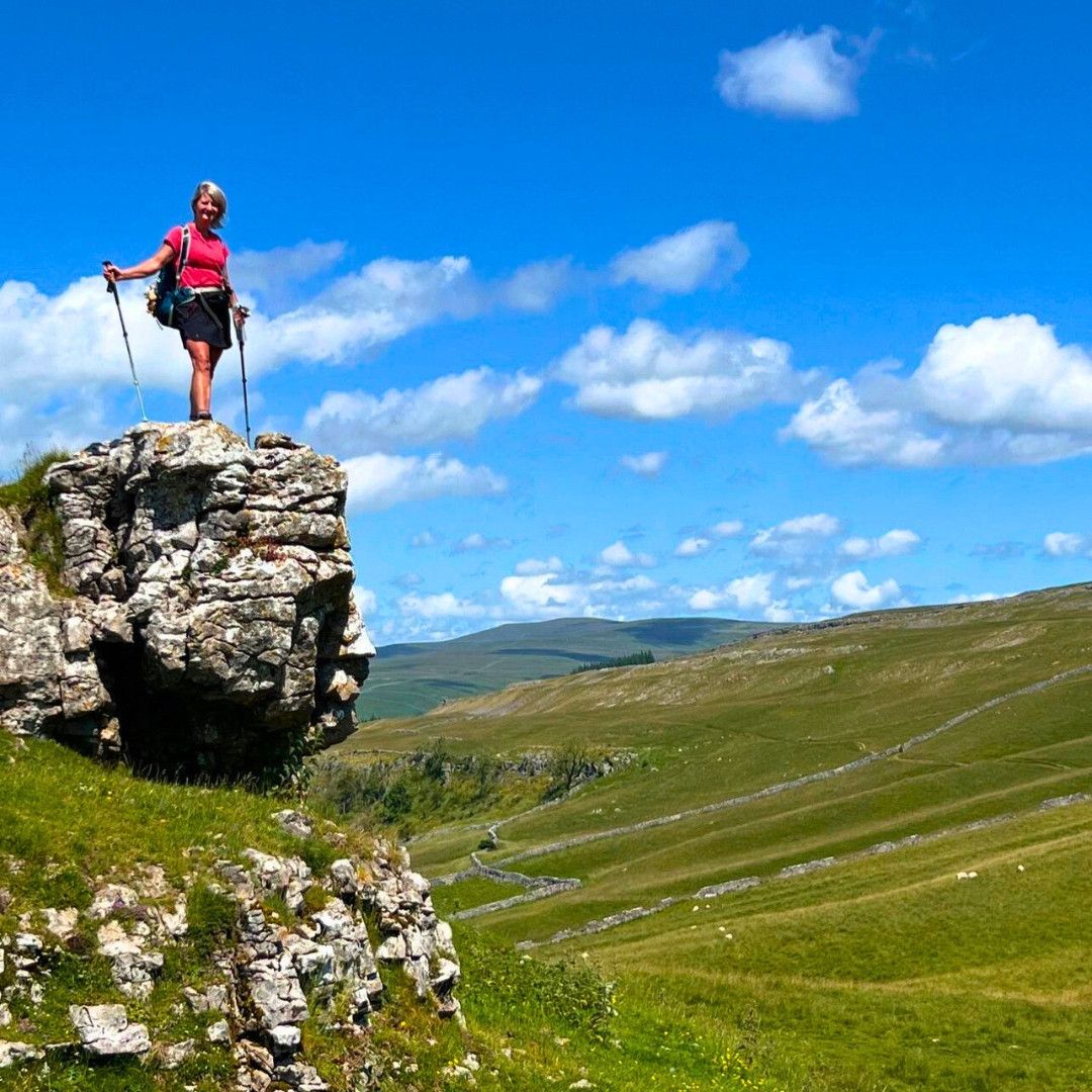 Walker above the limestone landscapes of the Yorkshire Dales on the Dales Way