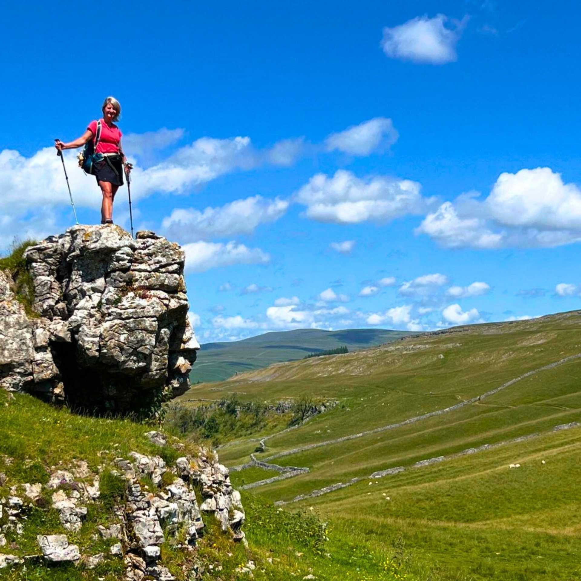 Walker above the limestone landscapes of the Yorkshire Dales on the Dales Way