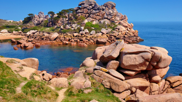 Rounded pink granite rocks and clear water on Brittany’s Pink Granite Coast