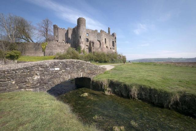Image of Laugharne Castle, with small bridge over the Taf Estuary