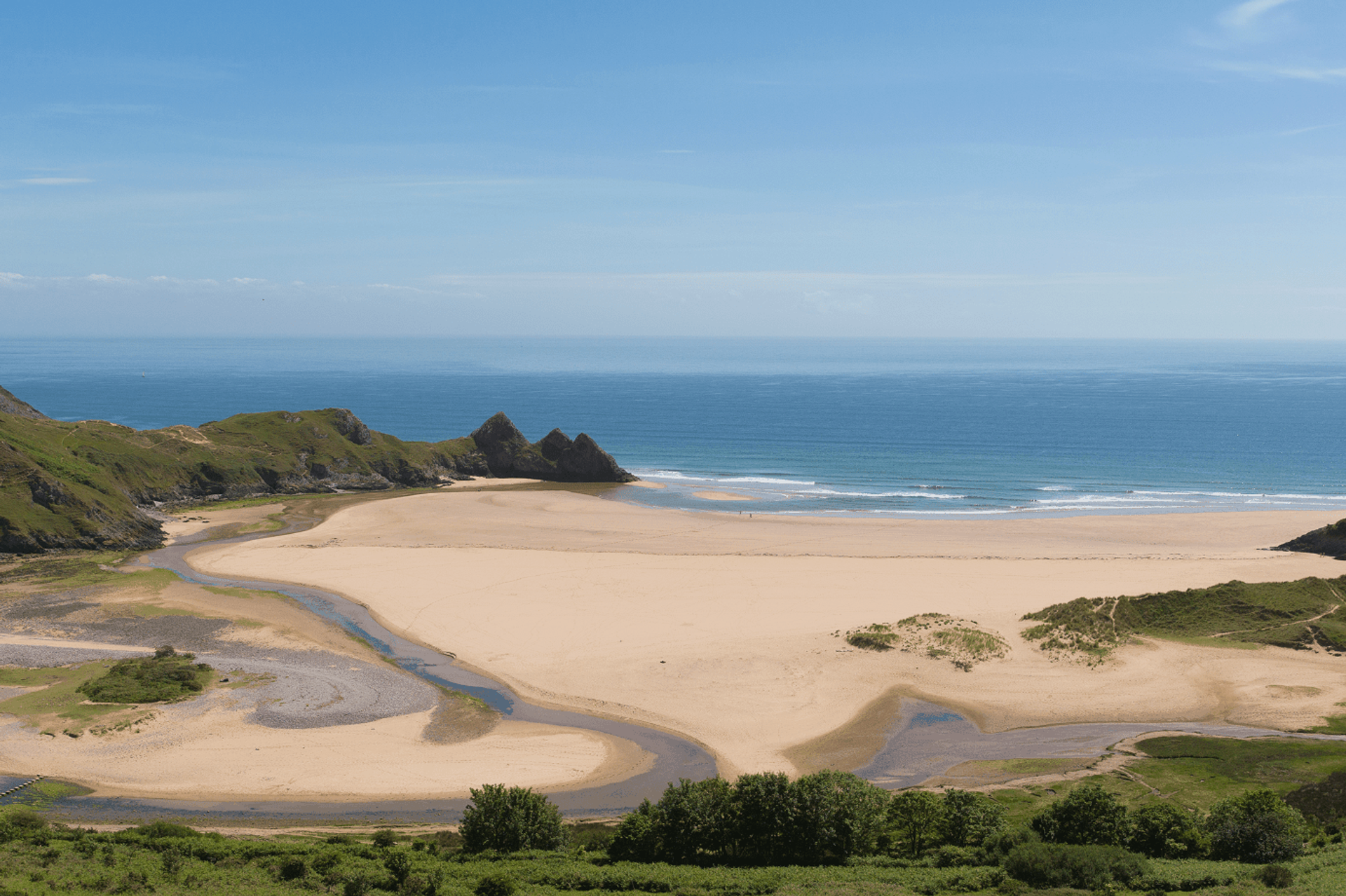 Three Cliffs Bay on the Gower Coast Path with limestone cliffs and wide sandy beach