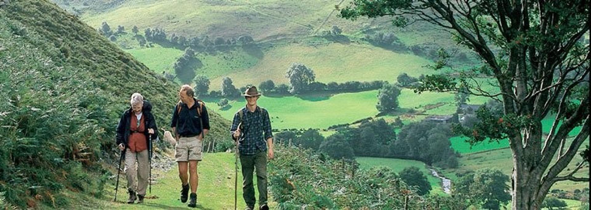 Three hikers travelling through the welsh countryside