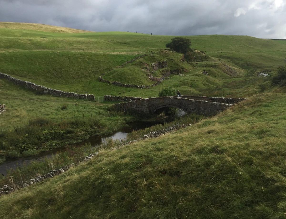 Stone bridge crossing a stream on the Coast to Coast Walk in the Yorkshire Dales