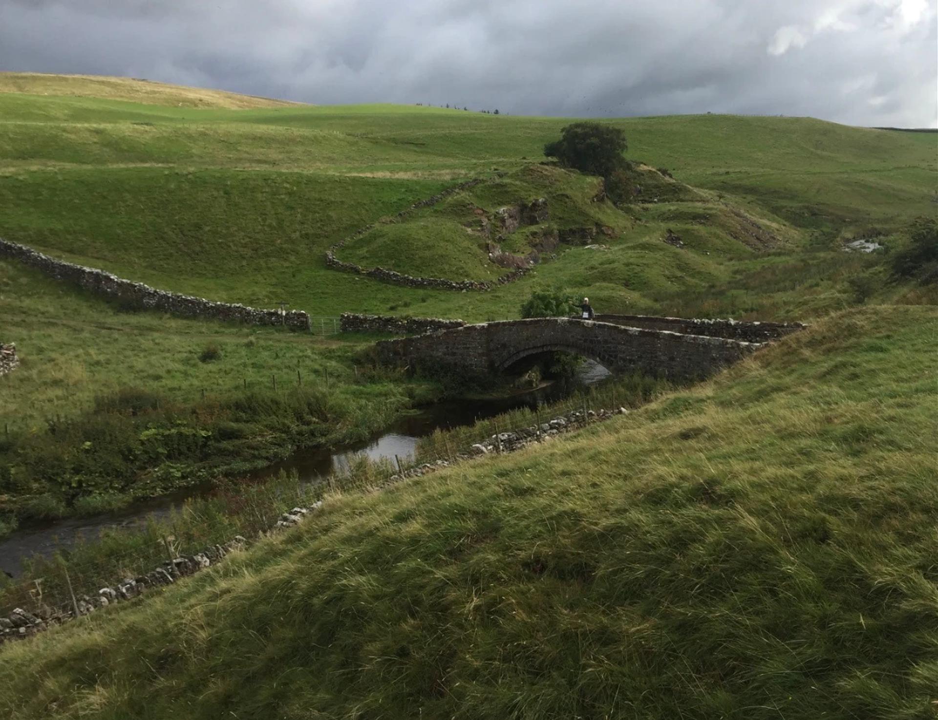 Stone bridge crossing a stream on the Coast to Coast Walk in the Yorkshire Dales