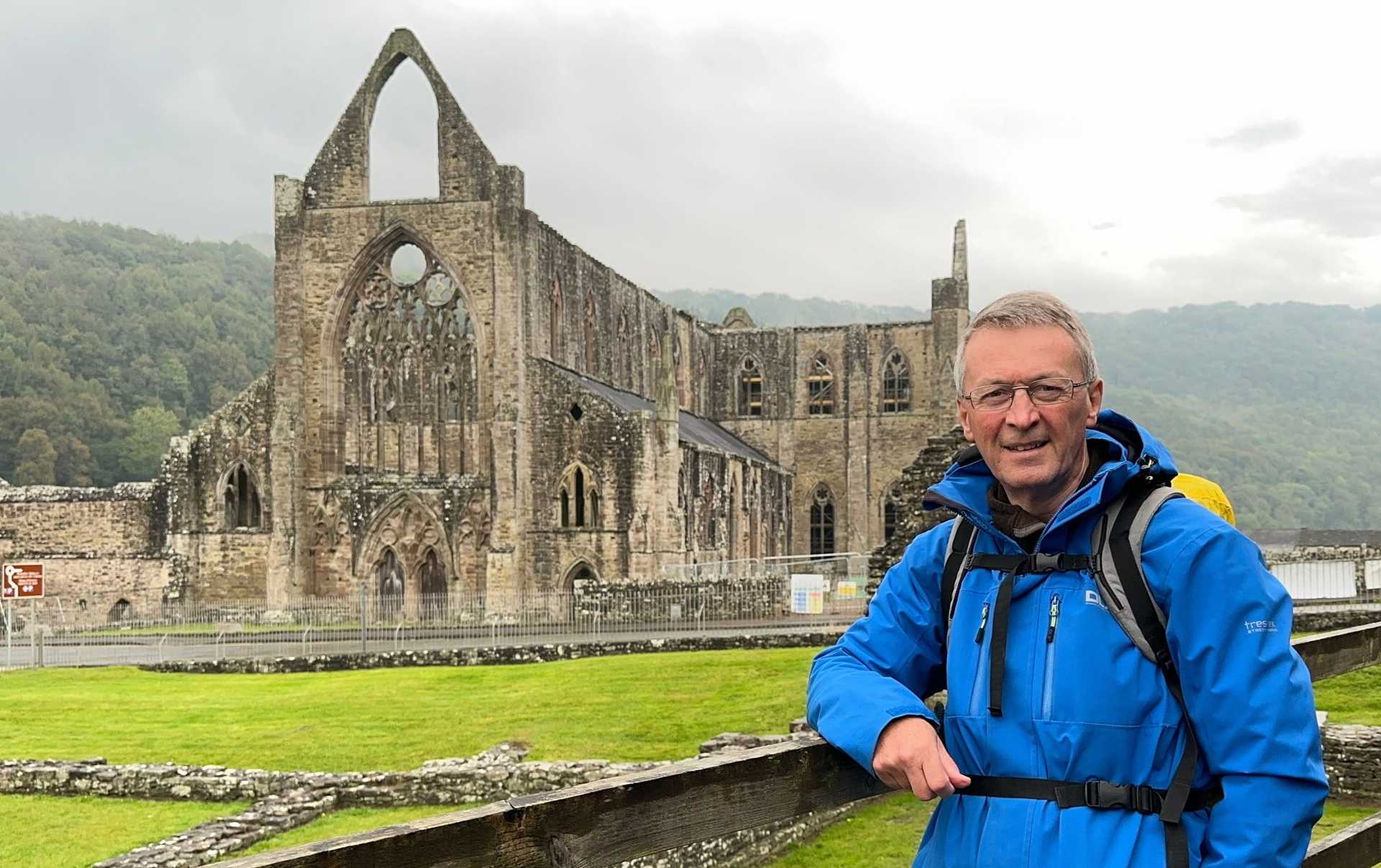 Walker at Tintern Abbey, Wales, on an overcast day