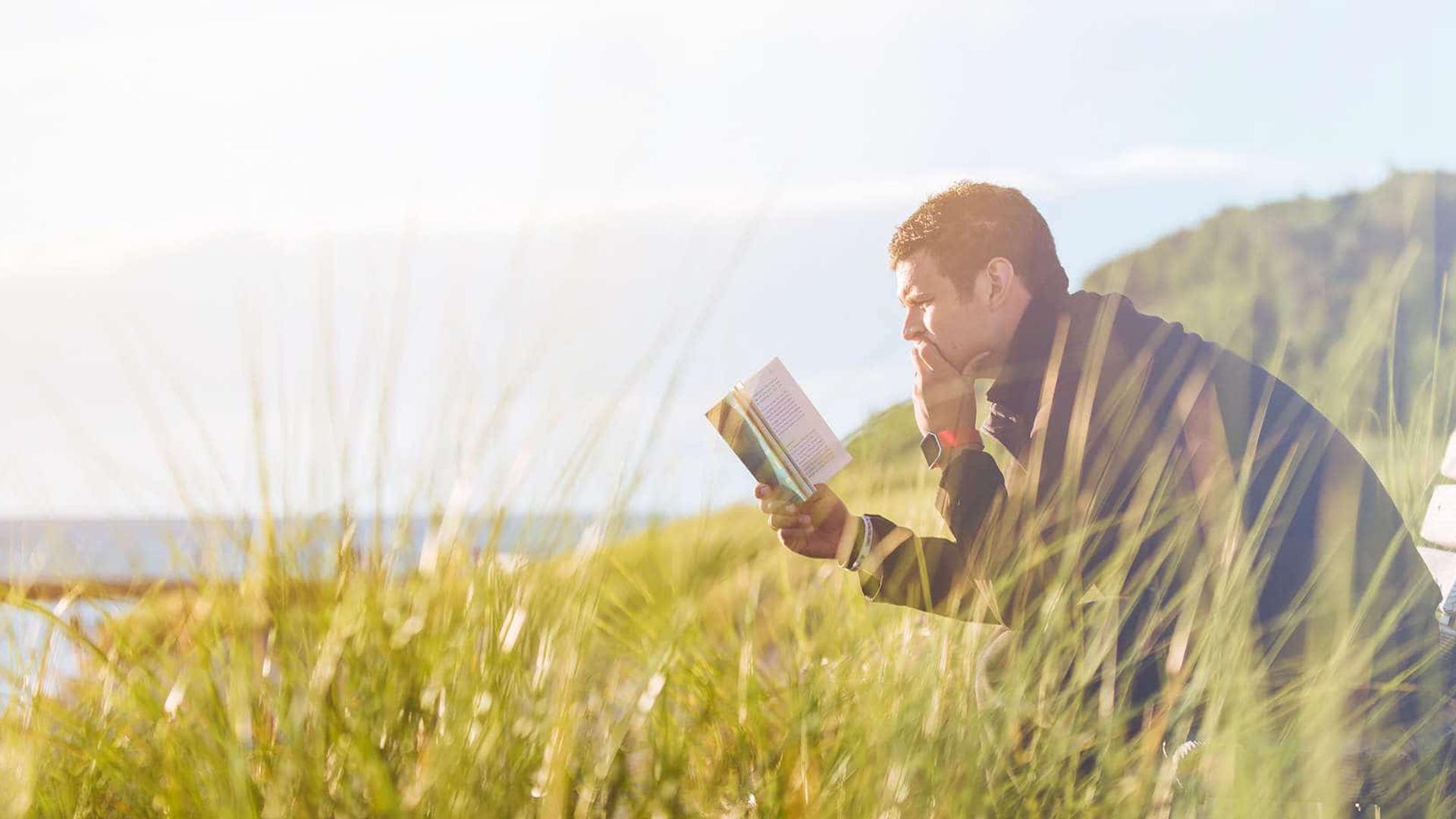 Man reading while hiking