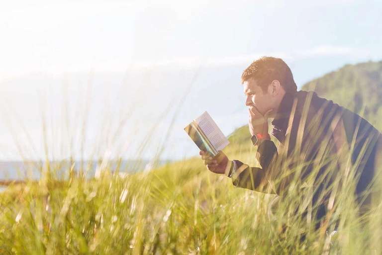 Man reading while hiking