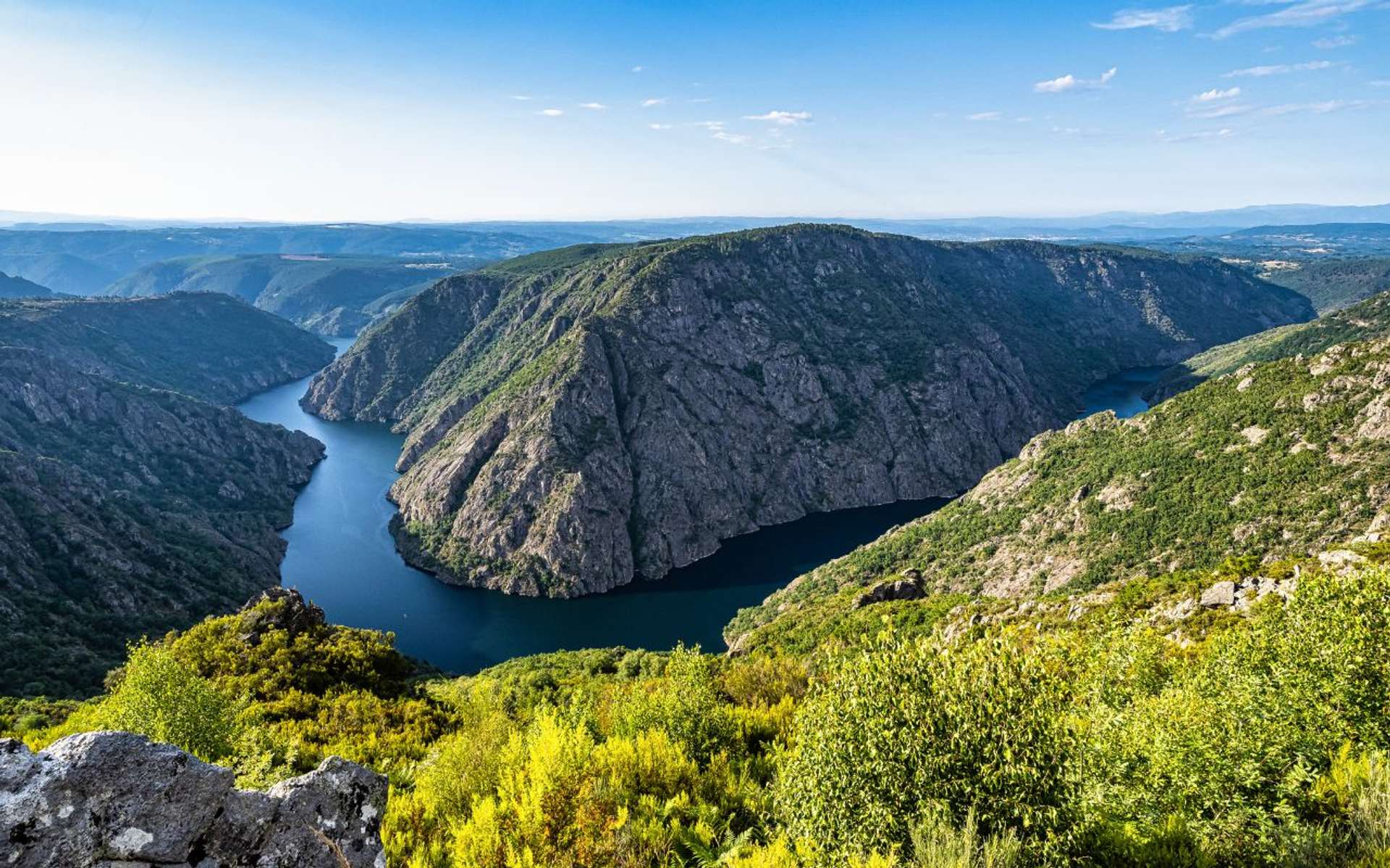 Ribeira Sacra canyon view over the Sil River with steep cliffs and winding water
