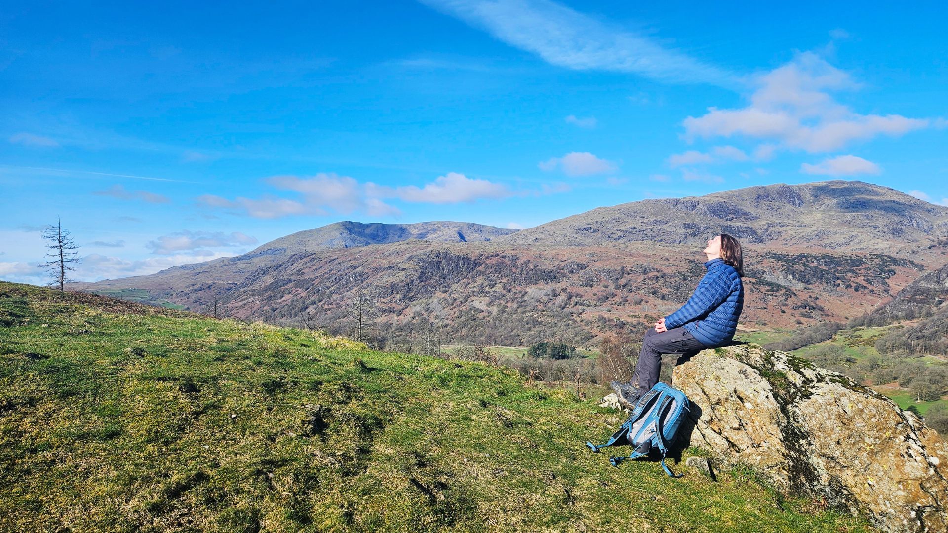 Walker relaxing on a clear day on the Cumbria Way on a self guided walking holiday