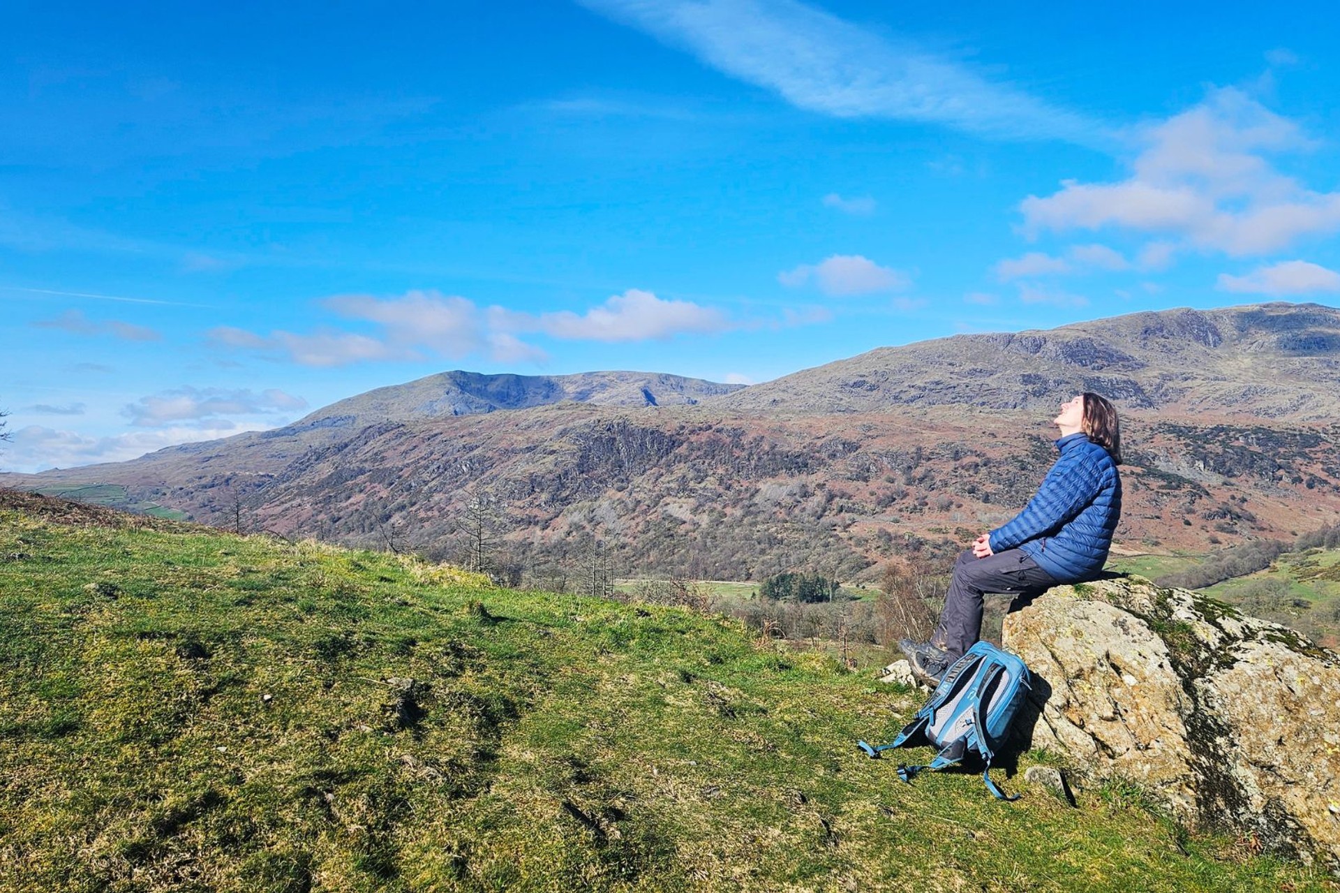 Walker relaxing on a clear day on the Cumbria Way on a self guided walking holiday